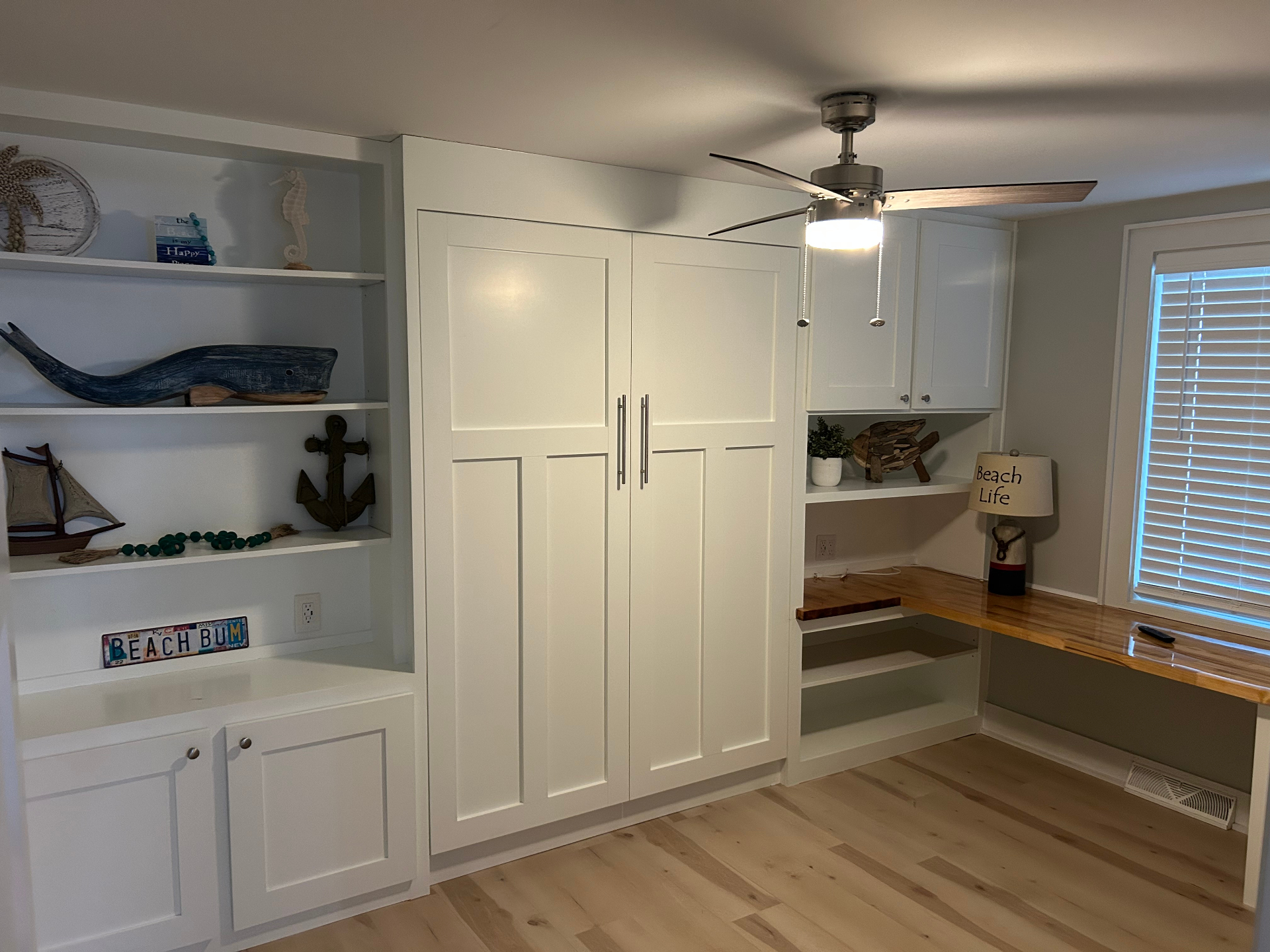 Murphy bed with built-in shelves and desk workspace