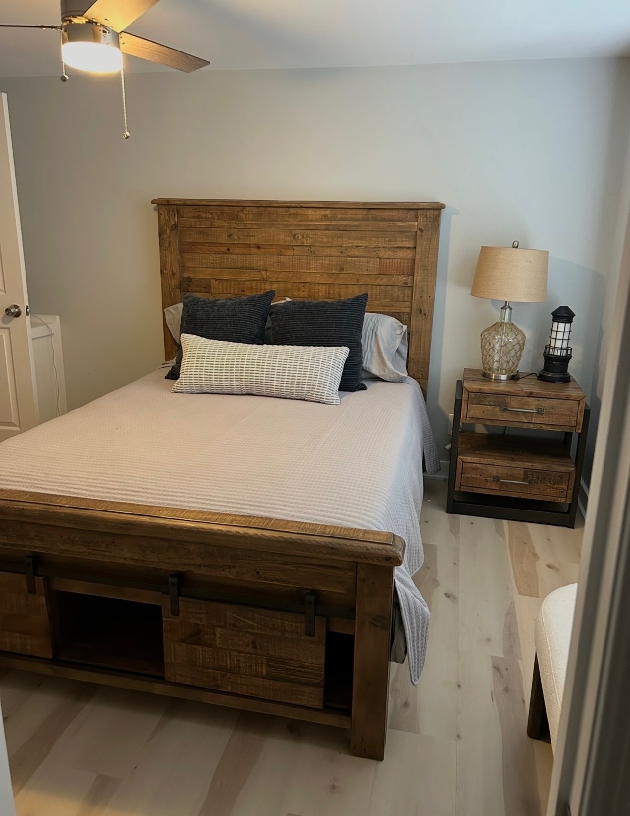 Queen bedroom with reclaimed wood bed and ceiling fan
