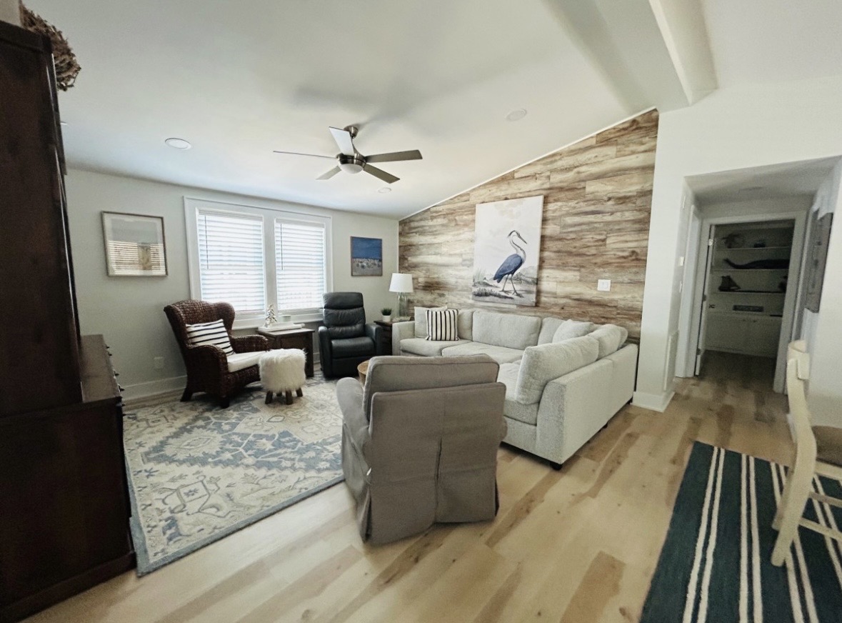 Living room with sectional and heron art